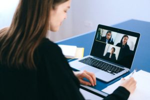 Woman video conferencing on laptop.